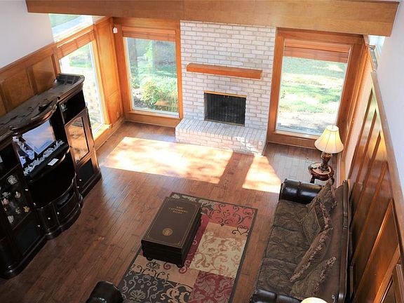 Great view of the den from the loft. Large space with wonderful hardwood floors. Great for entertaining or just relaxing with the family.