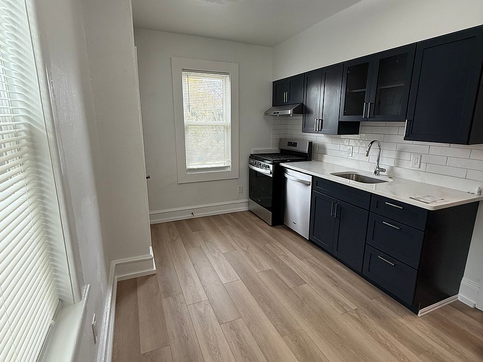 Newly remodeled kitchen with new navy blue cabinets and stainless steel appliances