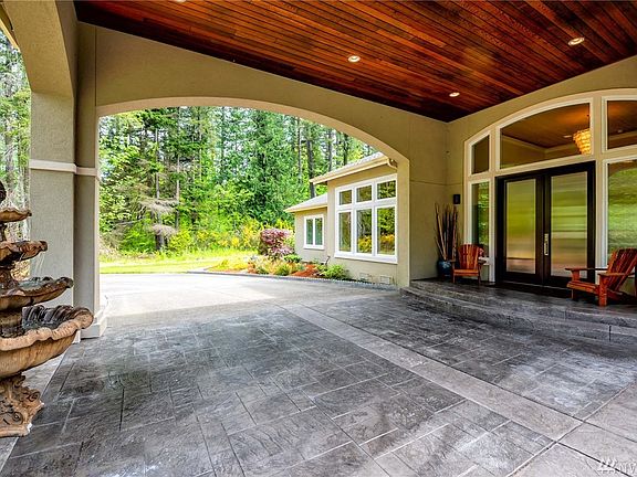 Wood lined portico entry with recessed lighting.
