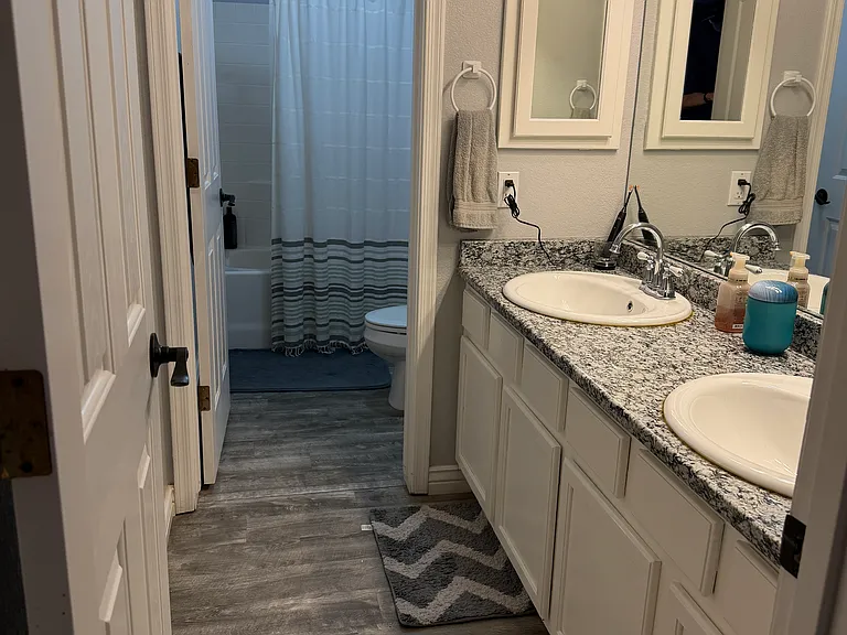 Second full bathroom features a spacious double vanity for added convenience.