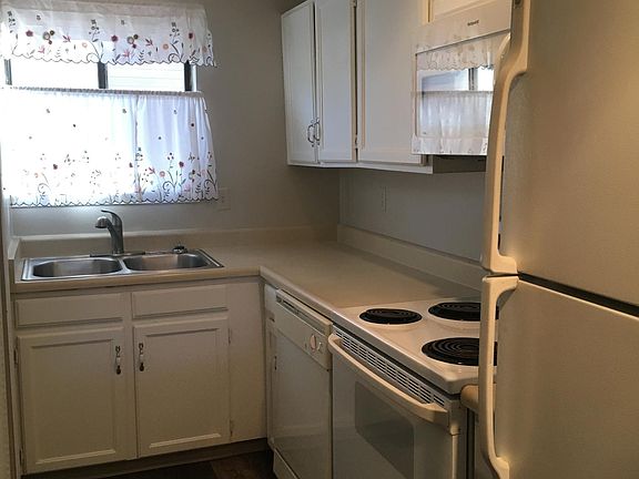 Kitchen with dishwasher, stove, microwave and refrigerator.
