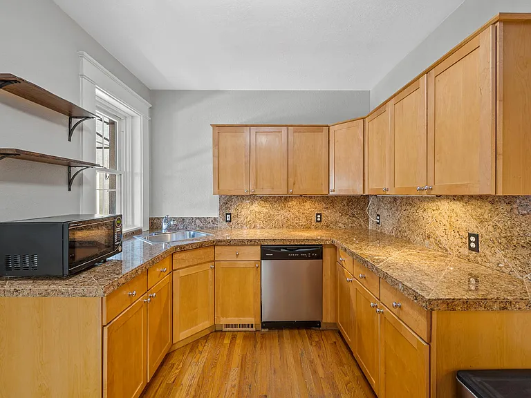 Kitchen with modern cabinets and granite counters.