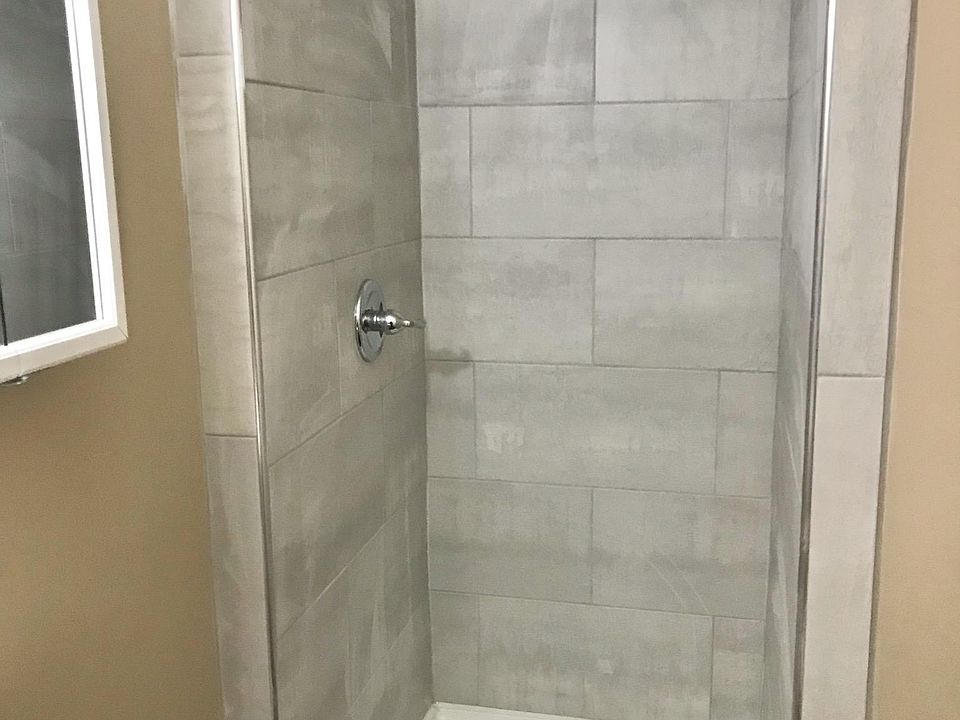 Ceramic tiled bathroom to keep water hot while you shower.