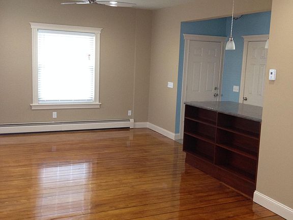 Living room, front door entrance, and storage closet.