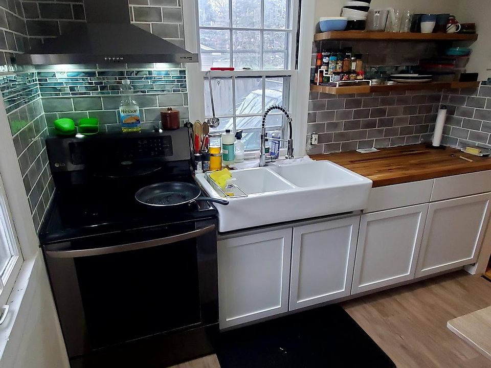 Stainless Steel stove & Venthood, porcelain tile backslash & Farmhouse sink.
