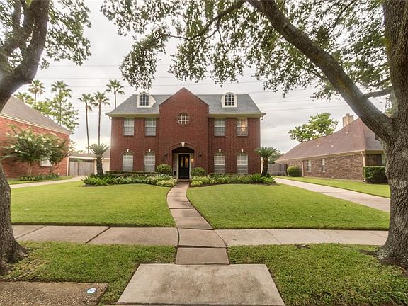 Home sweet home! 1522 S. Medio River Circle framed beautifully by these gracious oak trees!
