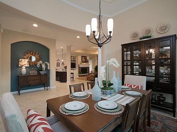 Spacious formal dining room with decorative chandelier, tray ceiling, and large windows allow you plenty of space to entertain guest or enjoy daily family dinners.