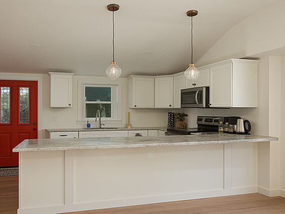 Open concept kitchen with brand new stainless appliances