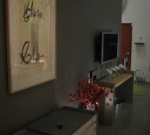 Great wall in the Great Room. Vintage Ice cooler, wall mounted flat panel tv and console table