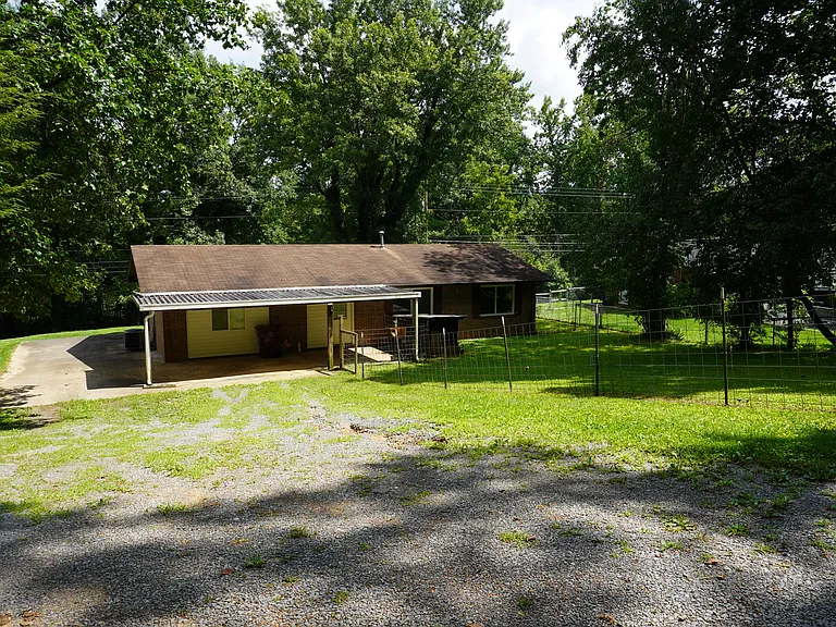 Backyard and gravel driveway