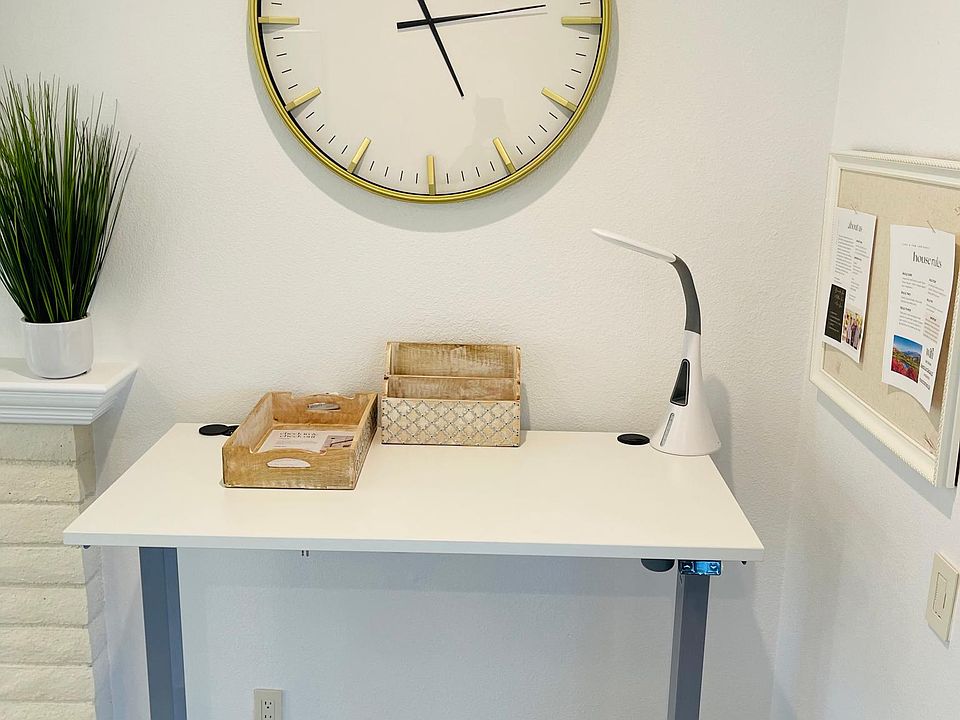 Workspace! This is a standing desk with a view of the patio and outdoor area. There are USB and plug chargers on the desk.