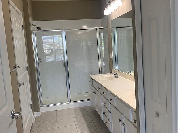 Master bathroom with double sinks and private potty area with a linen closet. The master bathroom has a bidet.