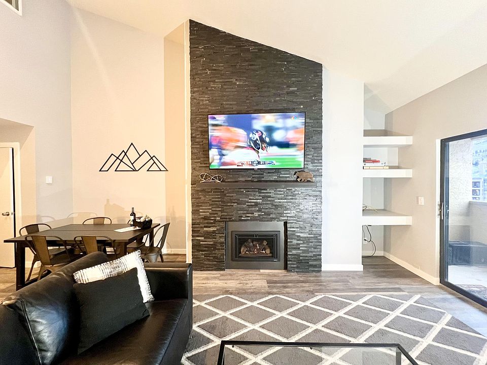 Living room with large sofa-bed sectional and storage chaise lounge, 65 in LED TV, fireplace, balcony with grill and sweeping views of Beaver Creek mountain