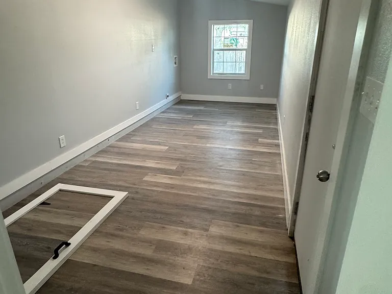 Back room with laundry hookups and basement. This room has a door to backyard access.