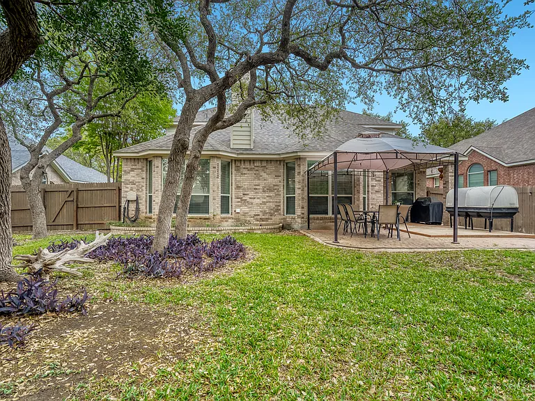 large fully fenced backyard with pergola