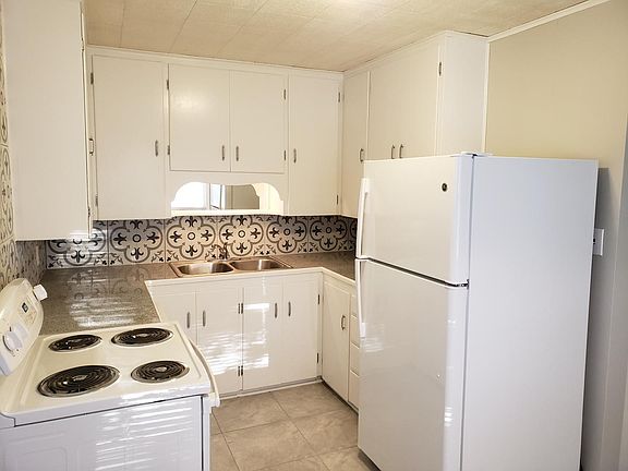 All new appliances, granite tile countertops with new floor tile and backsplash. Has Breakfast nook on other side of kitchen and also connects to the backyard or basement entry from off this kitchen.
