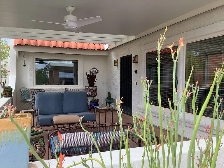 Large covered entrance sets the tone for comfort and style with deep-seated club chairs, a glider and a table for two. Enjoy the privacy and lovely Mountain View with your cup of coffee.