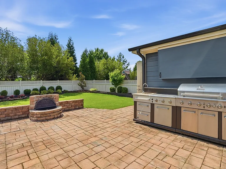 Backyard with outdoor kitchen and wood fireplace