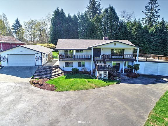Welcome Home! Beautiful traditional basement rambler on 1+ ACRE. Wonderful private setting located in Lea Hill. It features home with two garages that hold up to five cars,  A/C and more.>