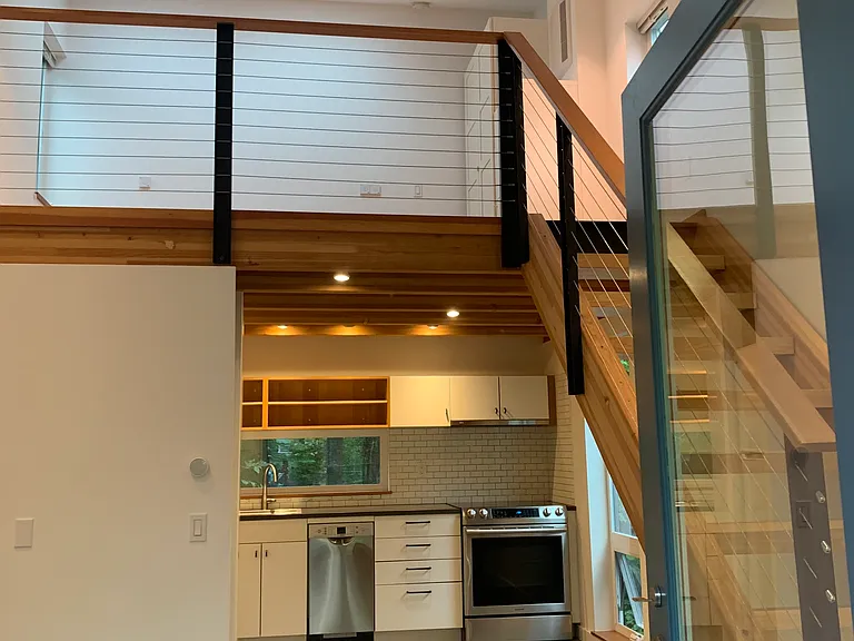 Walking in. Open living/dining/kitchen areas, with concrete floors. Lofted bedroom upstairs.