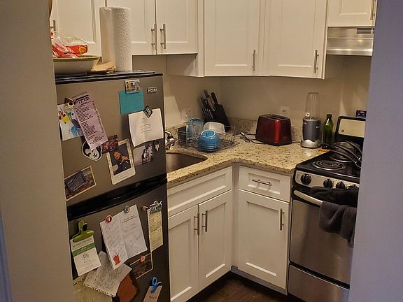 Kitchen with granite counter-tops, hardwood floors, and new stainless appliances
