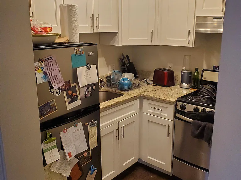 Kitchen with granite counter-tops, hardwood floors, and new stainless appliances