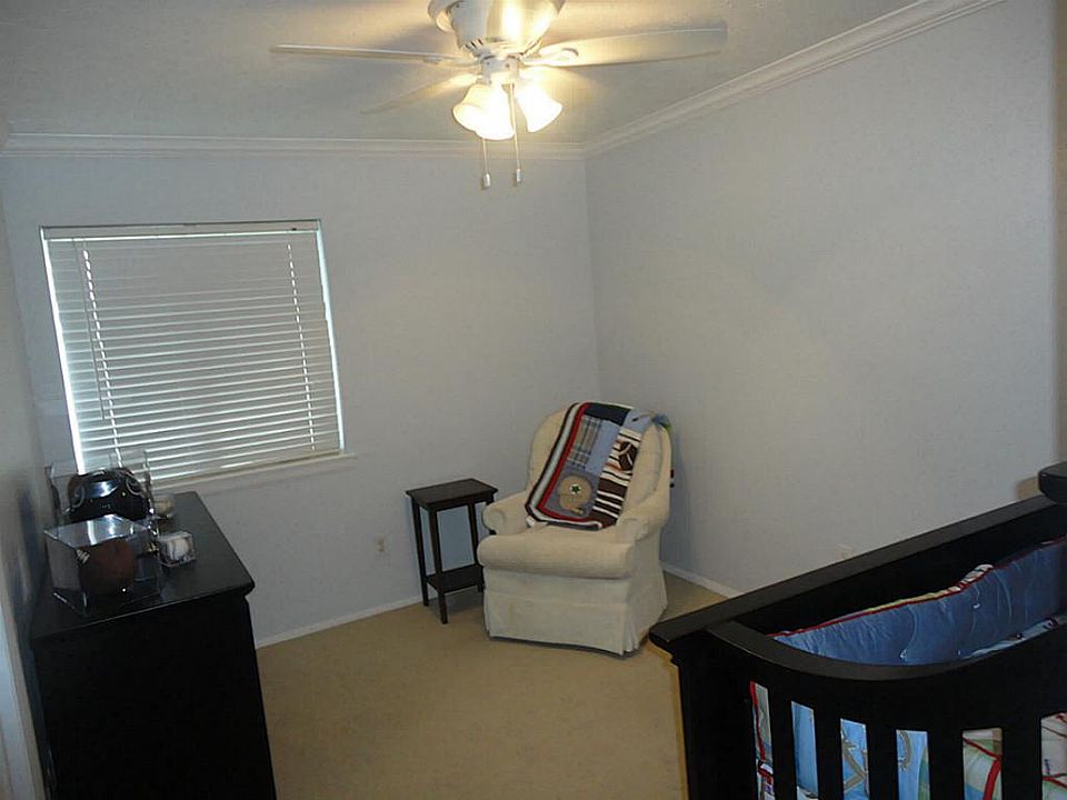Large secondary bedrooms offer crown molding, ceiling fans, and new paint.