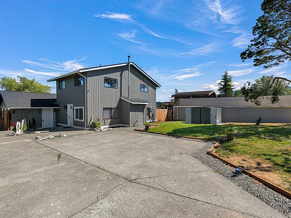 Front view of property with parking spaces and driveway