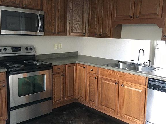 Kitchen view with see thru bar to living room