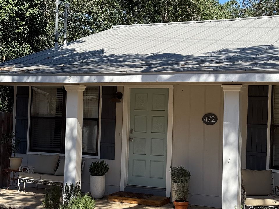 Pave stone sidewalk leads to front porch and entry door.