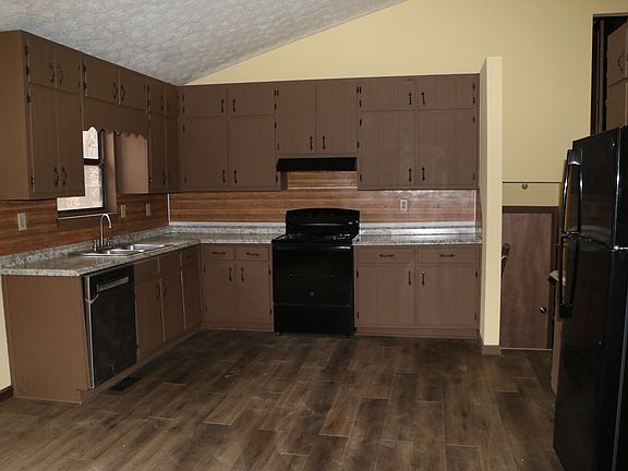 Kitchen with new dishwasher, stove and refrigerator