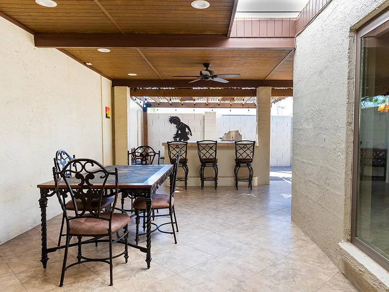 Covered outdoor dining table under skylight