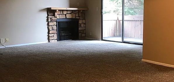 Living room with gas fireplace and patio.