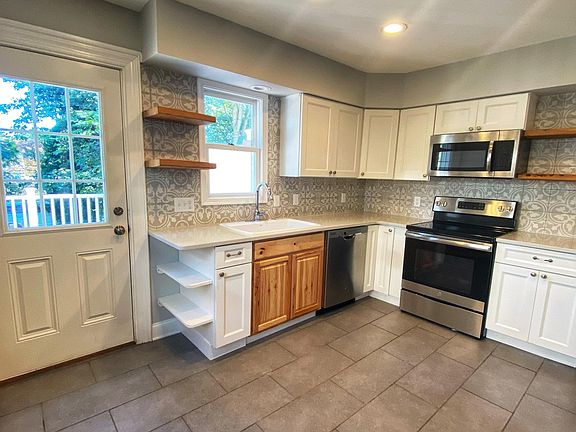 Updated kitchen with tile flooring, backsplash, stainless steel appliances. Private rear entrance to outdoor deck.