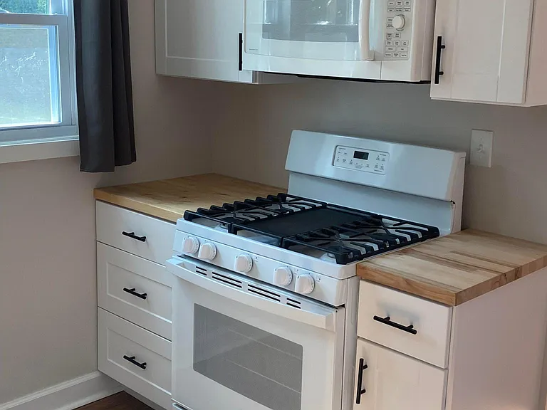 Stove, microwave and plenty of cabinets