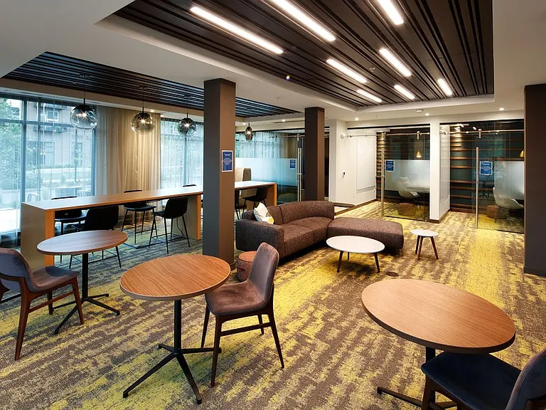 Phase II Hive Co-Work Lounge with separate seating areas and private office spaces, perfect for working remote