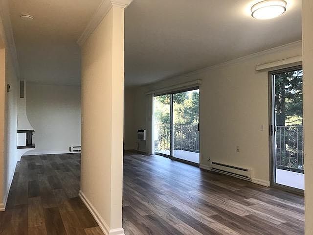 View from entry hall looking into spacious and open dining and living rooms