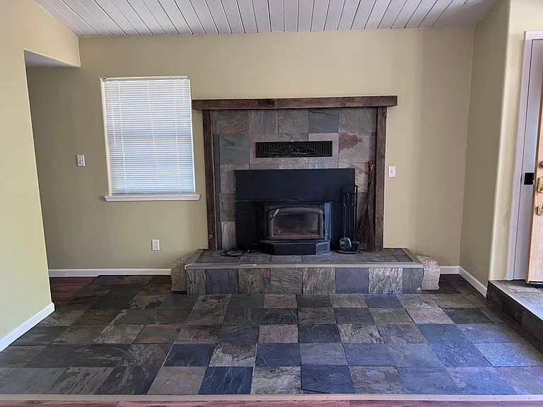 Wood stove insert and entry way with slate tile flooring & hearth