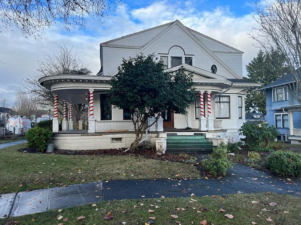 exterior of home with wrap around porch. Unit is right over the peak of the porch roof