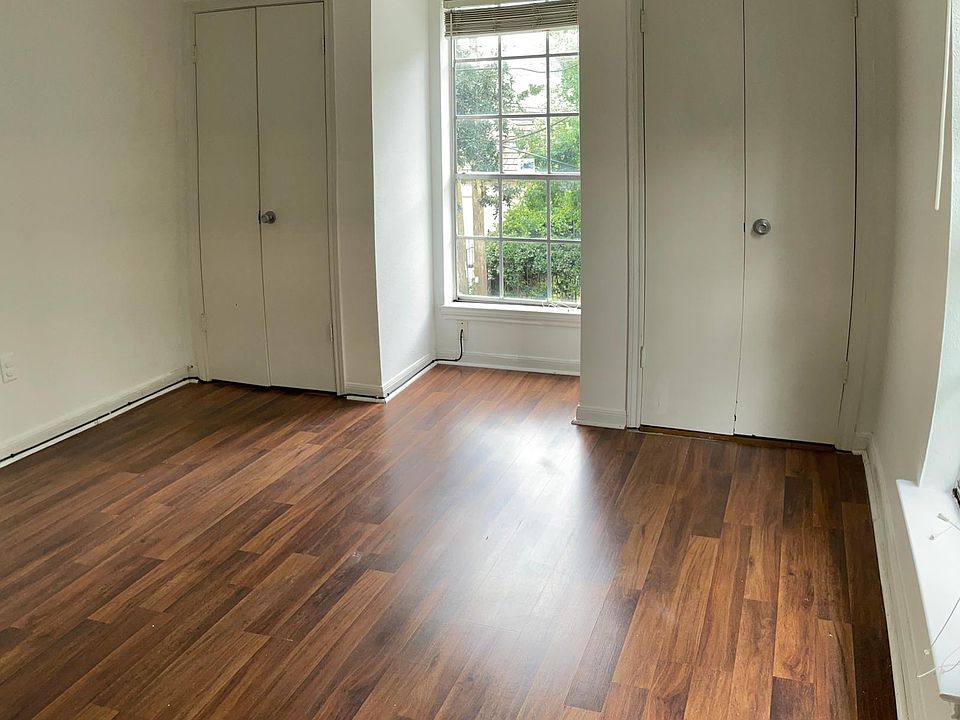 Second bedroom, view facing Amelia St. window, closets flanking.