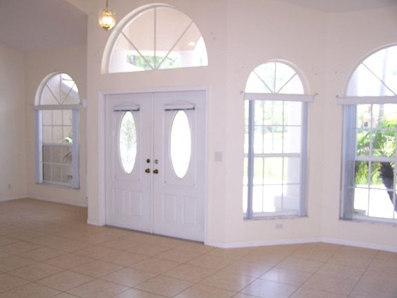 GLASS INSET FRONT DOOR, LOT OF WINDOWS FOR NATURAL LIGHT.