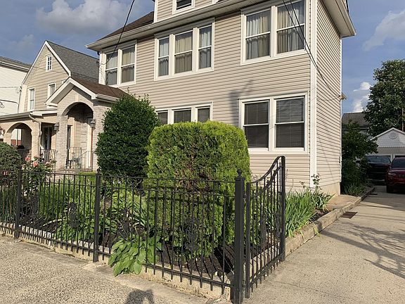 Front and side of house. Long driveway leads to backyard