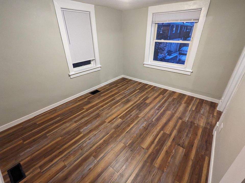 Living room looking out over front yard. Kitchen is through the door on the right.