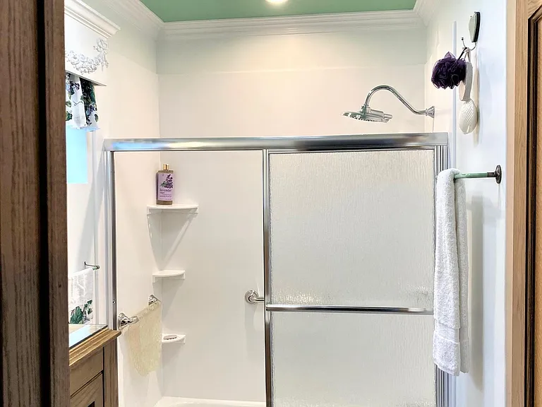 Studio Bath offers CORIAN Shower o/Tub w/Glass Door Enclosure, Rain Showerhead, Safety Rails, & Exhaust Fan that can sync up to Music from your iphone