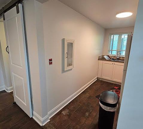 View of Kitchenette with range, refrigerator and sink with brick pavers