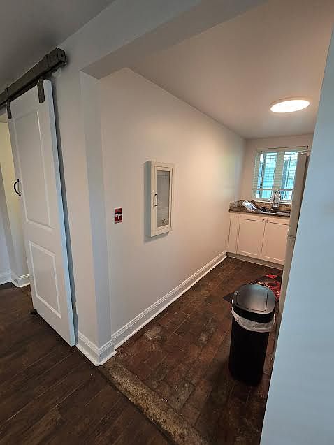 View of Kitchenette with range, refrigerator and sink with brick pavers