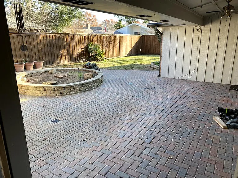Spacious brick patio in backyard