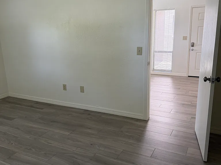 Bedroom looking toward living room and front door.