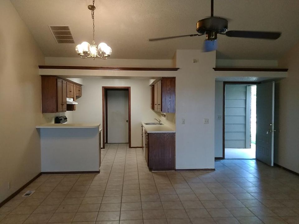 Carpets in living room and in bedrooms are new. From living room looking into kitchen and at front entry