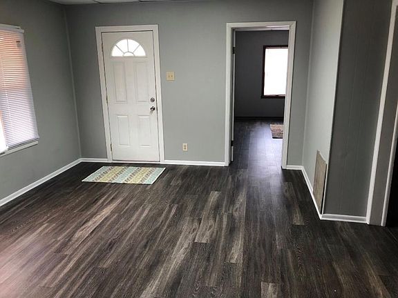 Living room photo # 3. Front exterior door on your left and bedroom door on the right